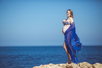 Young pregnant woman relaxing on a beautiful beach