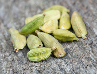 cardamom pods on wooden surface