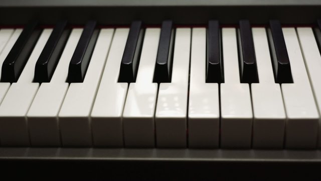 dolly shot of a piano keyboard