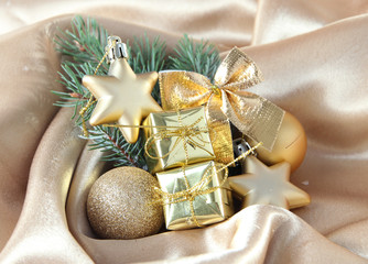 Fototapeta na wymiar Beautiful Christmas decor on golden satin cloth