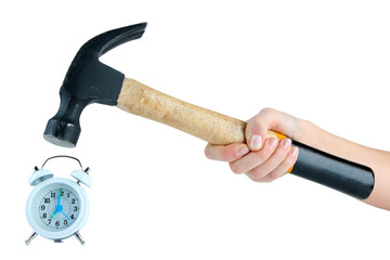 Hammer in hand and alarm clock isolated on white