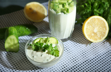 Cucumber yogurt in glass and bowl,