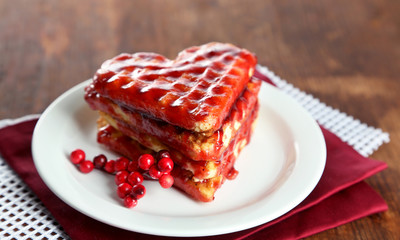 Sweet Belgium waffles with jam, on wooden table background