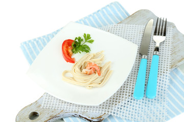 Pasta with shrimps on white plate, isolated on white