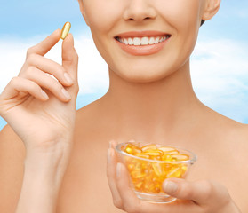 beautiful woman with omega 3 vitamins