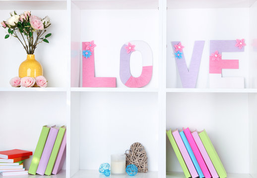 White shelves decorated with handmade knit word
