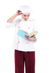 Professional chef  with book, in white uniform and hat,