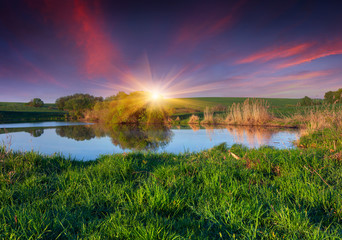 Fototapeta na wymiar Colorful spring landscape on the fishing pond.