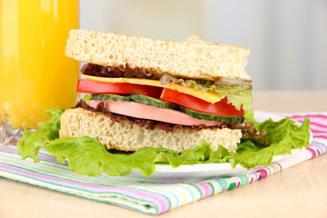 Fresh and tasty sandwich on plate on table on light background