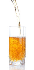Juice pouring into glass isolated on white