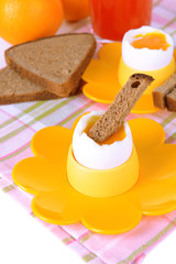 Boiled eggs in egg cups on table close-up