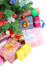 Decorated Christmas tree with gifts, close up,  isolated