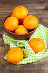Ripe sweet tangerines with spices in bowl,