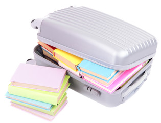 Suitcase with books isolated on white