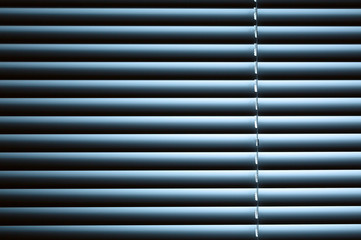 Obraz premium Closed Venetian Blinds Under Night Light