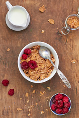 Healthy breakfast: cornflakes with milk and raspberries