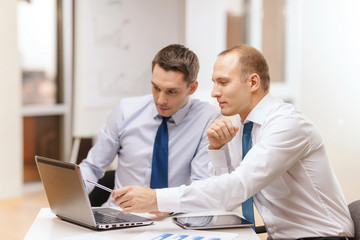 two businessmen having discussion in office