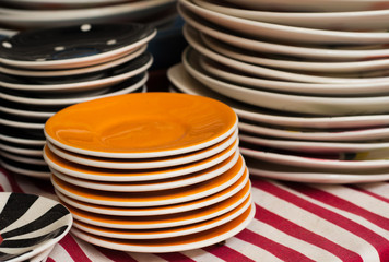 stack of colour porcelain on table cloth