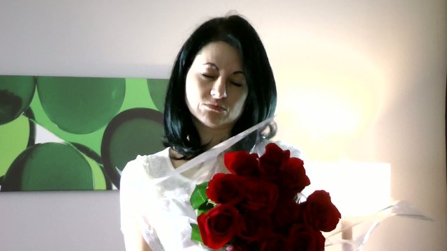 Beautiful woman giving flowers feeling guilty