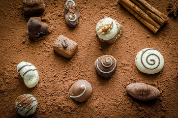 Luxury chocolate candies with cocoa background