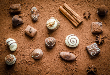 Luxury chocolate candies with cocoa background