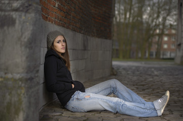 sad young woman with knitted hat