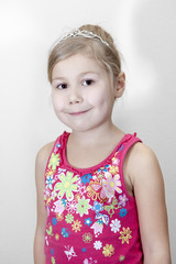 Smiling young girl with diadem in blond hair