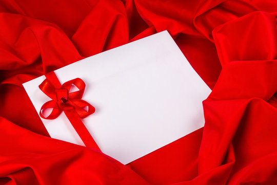 love card with ribbon on a red fabric