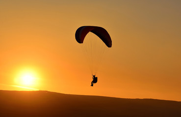 paraglider at sunset