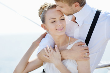 Happy bride and groom on a yacht