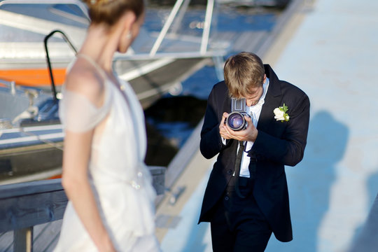 Groom shooting his bride with an old camera