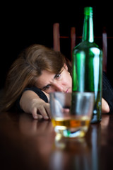 Dark emotional image of a sad drunk woman