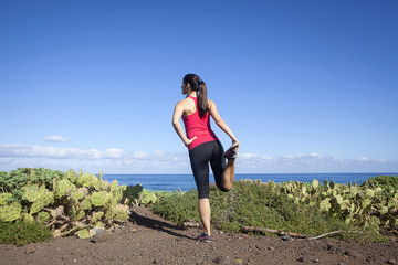 Young woman stretching before running outdoor