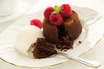 Chocolate fondant (pudding) with raspberries.