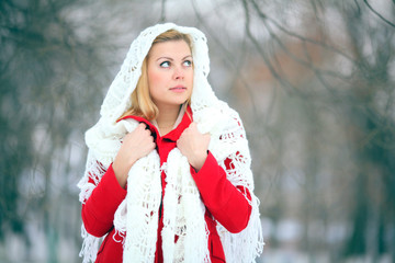 beautiful blonde in a traditional Russian scarf winter snow