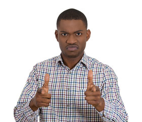 Angry young man pointing fingers at you camera gesture 