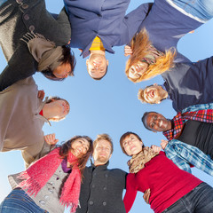 Multiracial People Holding Hands in a Circle, Low Angle View