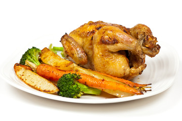 Whole roasted chicken and various vegetables