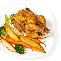 Whole roasted chicken and various vegetables