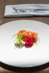 Image of tasty salmon on dish with knife and fork