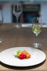 Image of tasty salmon on dish with white vine