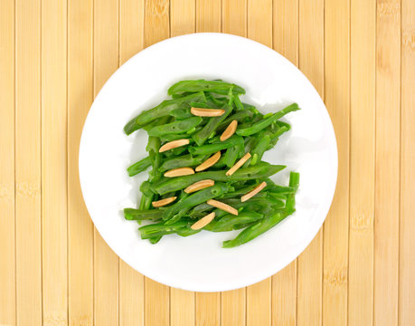 Sliced Green Beans With Almonds On A White Plate