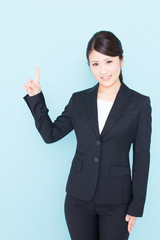 young asian businesswoman showing on blue background