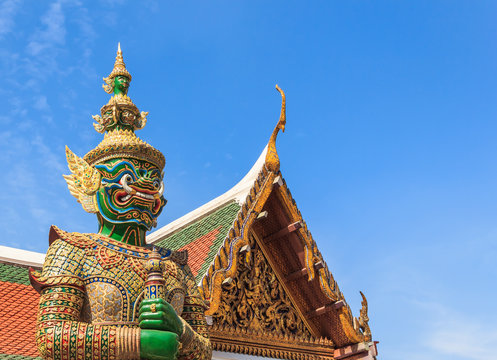 Green Demon  Guardian Statue against Blue sky Background