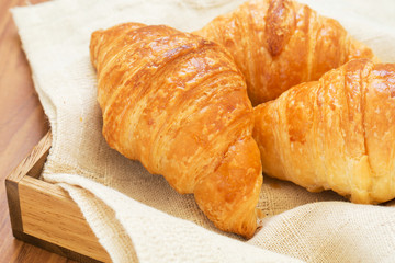 Croissants on wooden tray
