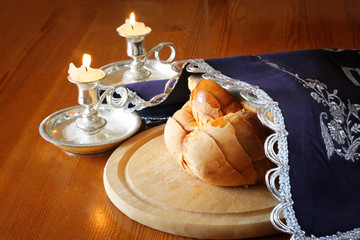Sabbath image. challah bread and candelas on wooden table  