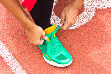 Tying sports shoe on the running track