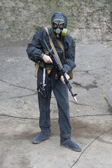 Sailor  marine  in chemical  protective  suit  with  a  gun  in