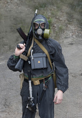 Sailor  marine  in chemical  protective  suit  with  a  gun  in