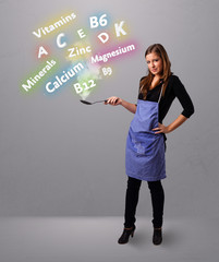 Young woman cooking vitamins and minerals